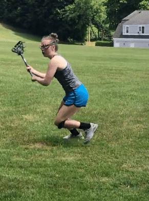 Photograph of a teen girl play lacrosse. 
"I was a coordinated athlete...Who was this person that had taken over my body?"